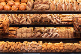Types of bread on shelves in a store.