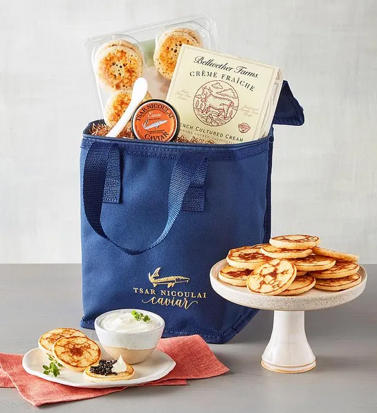 Caviar estate gift with a bag of caviar, bread, and creme fraiche.