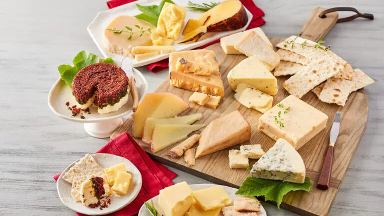 Cheese snacks on a board and plates.