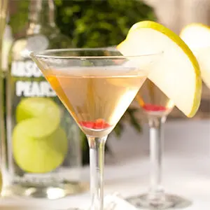 Christmas dinner ideas with a pear martini with a slice of pear on the lip of the glass.