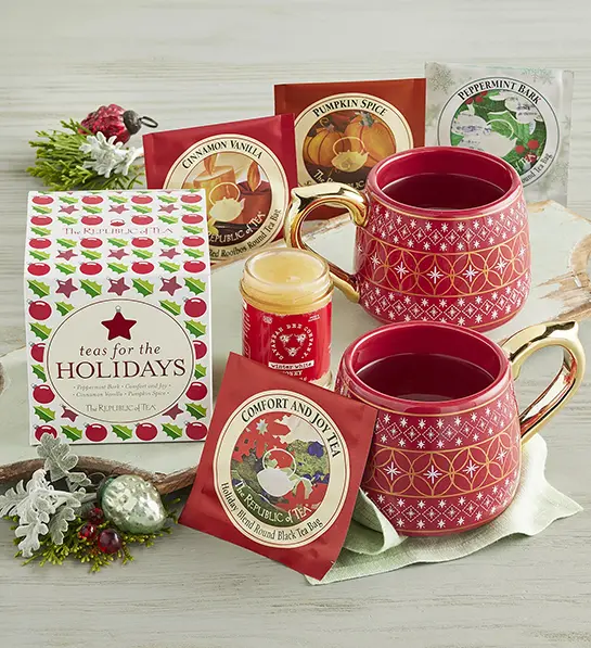 Christmas gift ideas for her with two Christmas mugs with a selection of tea.