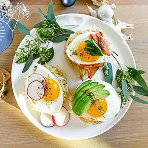 December recipes with a plate of latkes topped with eggs and avocado.