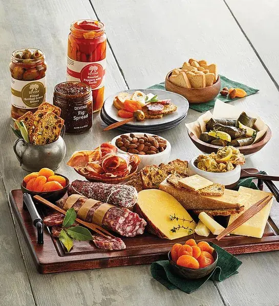 Gifting matrix with a group with a collection of meats, cheeses and other finger foods.