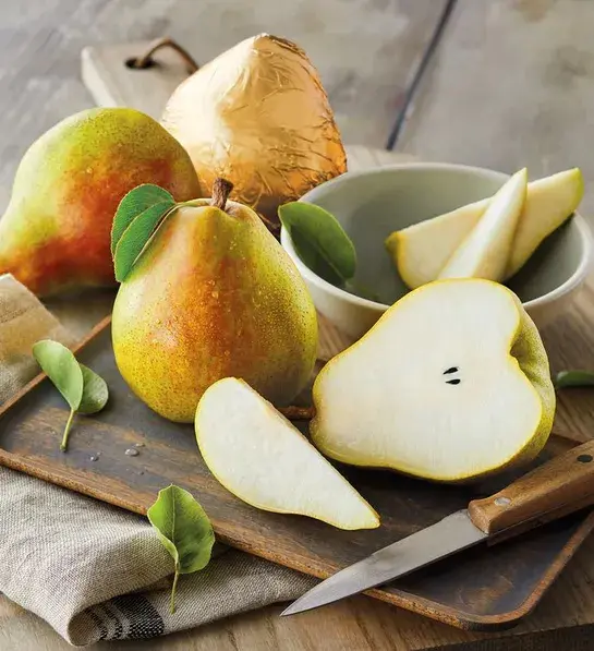 Gifting matrix with several whole and sliced pears on a wooden board.
