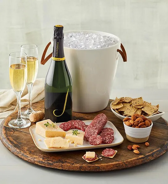 Gifting matrix with a bucket of ice next to a bottle of sparkling wine with two glasses.