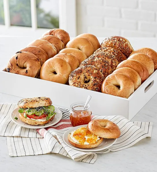 Gifts for coworkers with a box full of bagels with a plate of bagels in front of it.