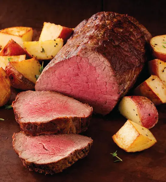 Gifts for coworkers with a sliced chateaubriand and roast potatoes.