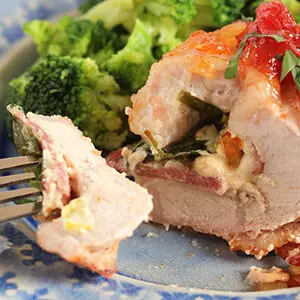 Pepper and onion relish pork tenderloin on a plate.