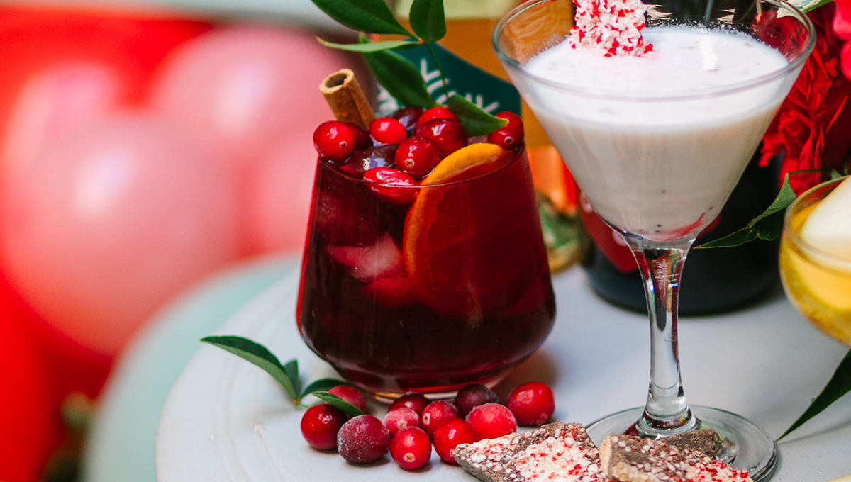 Drink station with a closeup of a holiday sangria cocktail in a glass.