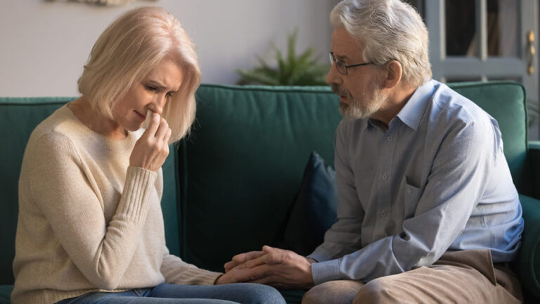 support grieving friends. Man consoling a woman who's crying.