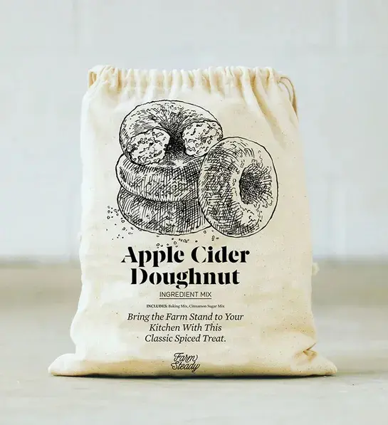 White elephant gift ideas with a bag full of apple cider doughnut mix.