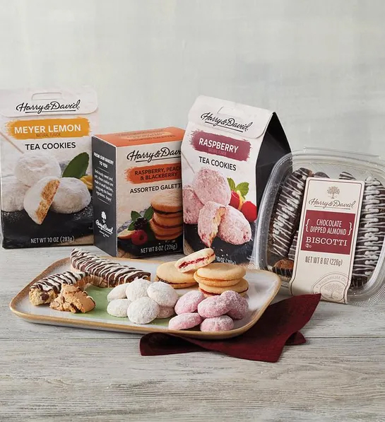 White elephant gift ideas with four boxes of different kinds of cookies with a plate of cookies in front.