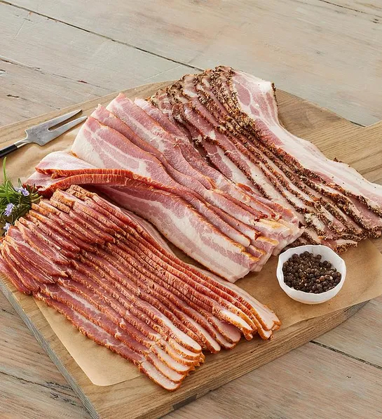 Best gifts for meat lovers with a cutting board with multiple kinds of bacon.