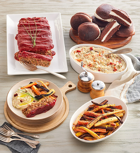 Meat loaf with several other side dishes and dessert.