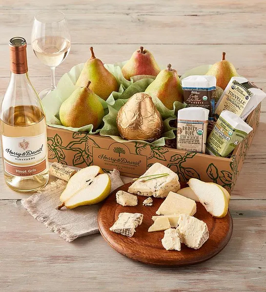 Galentine's Day gift ideas with a box of pears and cheese next to a bottle of wine.