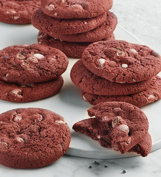 History of red velvet cake with a stack of red velvet cookies.
