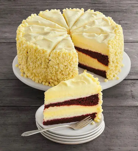 History of red velvet cake with a red velvet cheesecake on a platter.