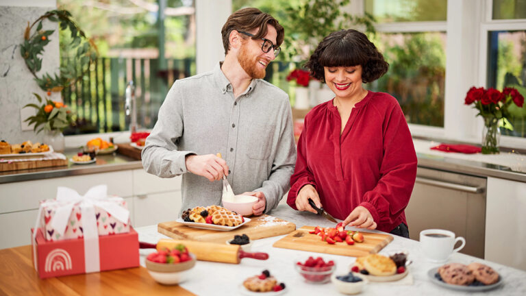 Man and woman making breakfast in their kitchen.