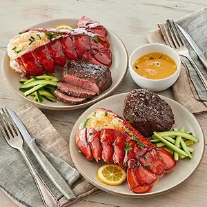 Romantic dinner ideas with two plates of lobster and steak.