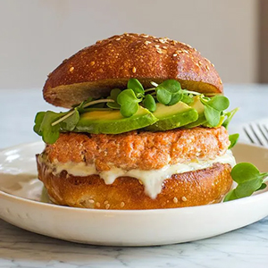 Salmon recipes with a salmon burger on a plate.