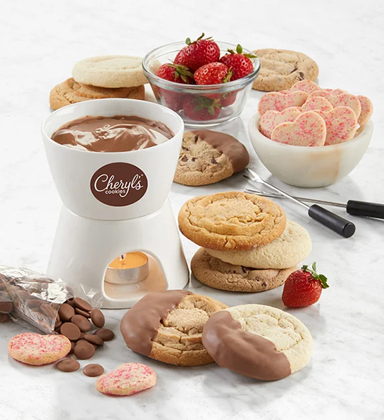 Valentine's Day gifts for her with a chocolate fondue set surrounded by cookies and fruit.