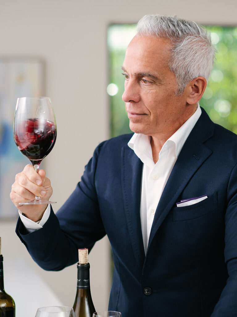 Geoffrey Zakarian swirling a glass of cabernet sauvignon.