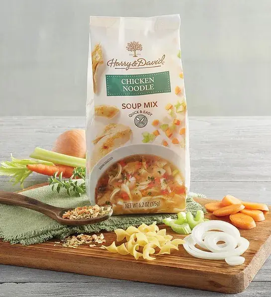 Chicken noodle soup mix in a bag surrounded by ingredients.