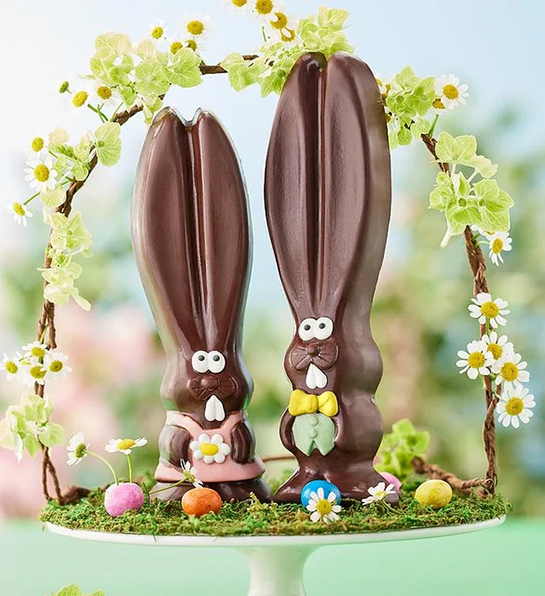 Easter basket stuffers with two chocolate Easter bunnies in a basket.