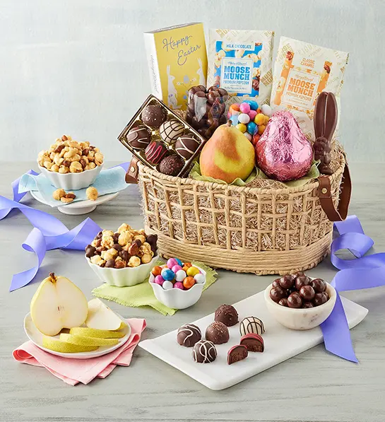 Easter gift ideas with a basket full of chocolate, fruit, and other snacks.