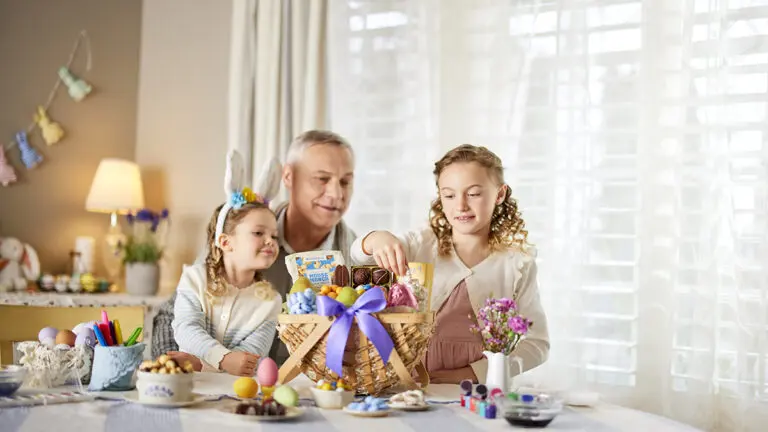 Easter gift ideas with a man and two young girls looking at an Easter basket.