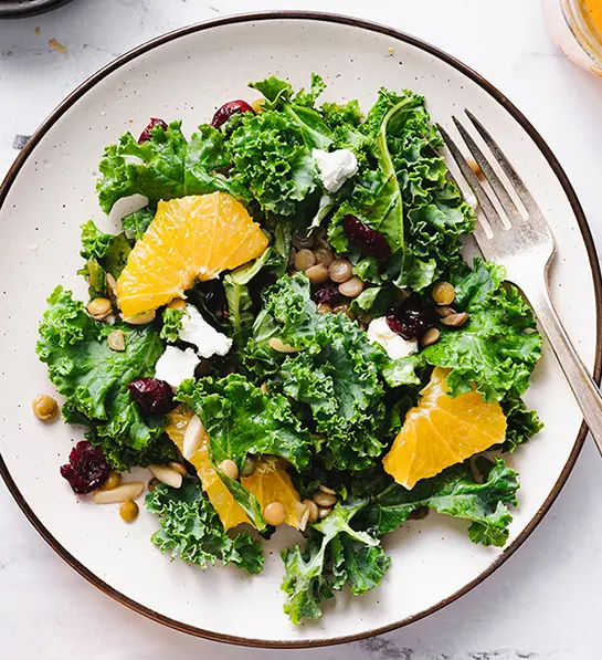 St. Patrick's Day food with a citrus kale salad on a plate.