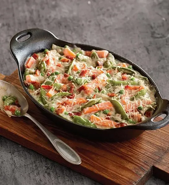 St. Patrick's Day food with a casserole dish of creamy snap peas with bacon.