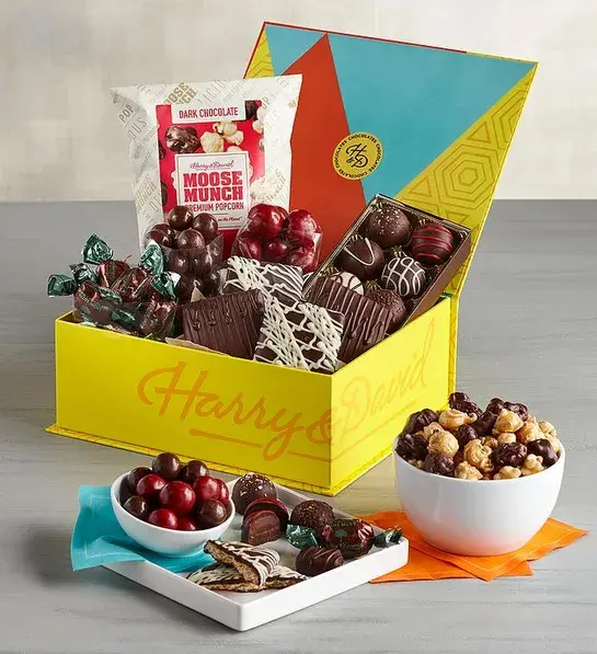 Types of chocolate and chocolate treats in a festive colored box.