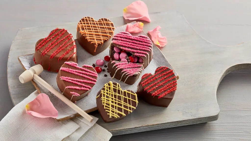 Types of chocolate hearts on a board.