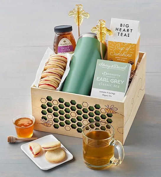 Undercover Snacks with a box full of tea, honey, cookies and other tea essentials.