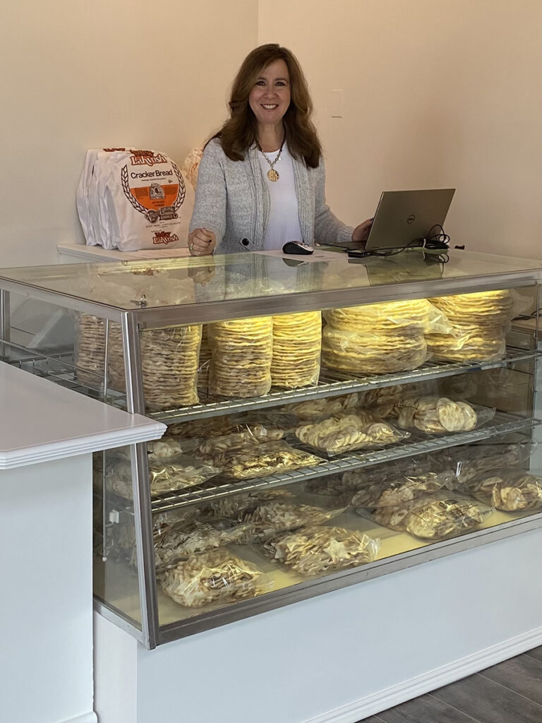 valley lahvosh baking company founder behind a counter.