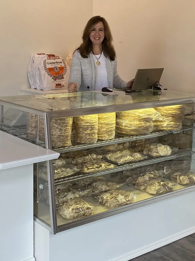 valley lahvosh baking company founder behind a counter.