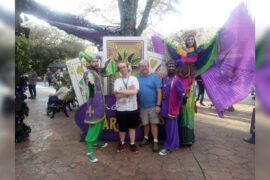 autistic care with a family celebrating Mardi Gras outside at a parade.
