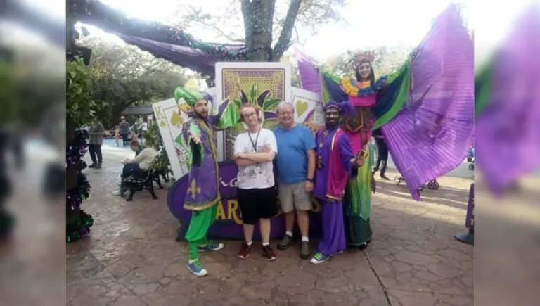 autistic care with a family celebrating Mardi Gras outside at a parade.