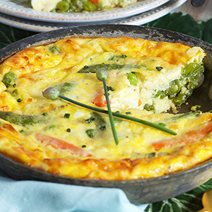 Easter brunch recipe with a frittata in a cast-iron skillet.