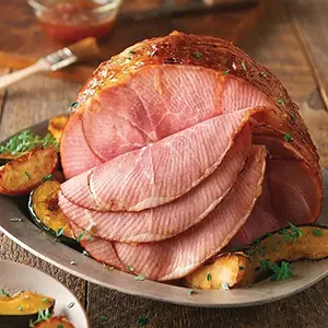 Easter brunch recipes with a spiral ham on a platter.