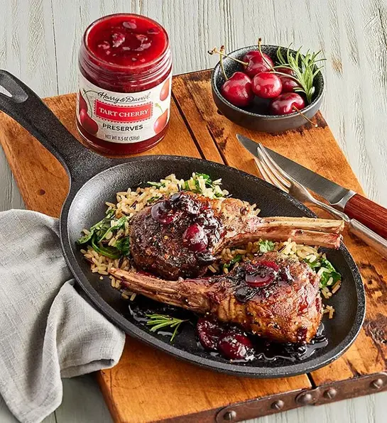 Lamb with cherry glaze in a cast-iron skillet.