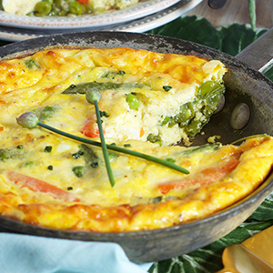 spring vegetables frittata in a cast-iron skillet.