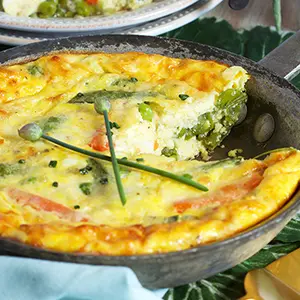 spring vegetables frittata in a cast-iron skillet.