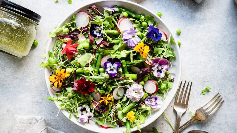 Spring vegetable salad in a bowl with flowers.