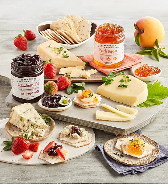 Fruit and cheese pairings with a spread of cheese, fruit, and preserves.