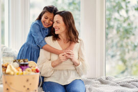 ideas for mothers day gifts daughter hugging mother from behind.