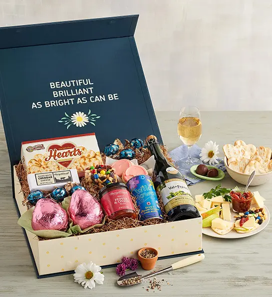 Mother-in-law gifts with a box of pears and sweet and savory snacks.