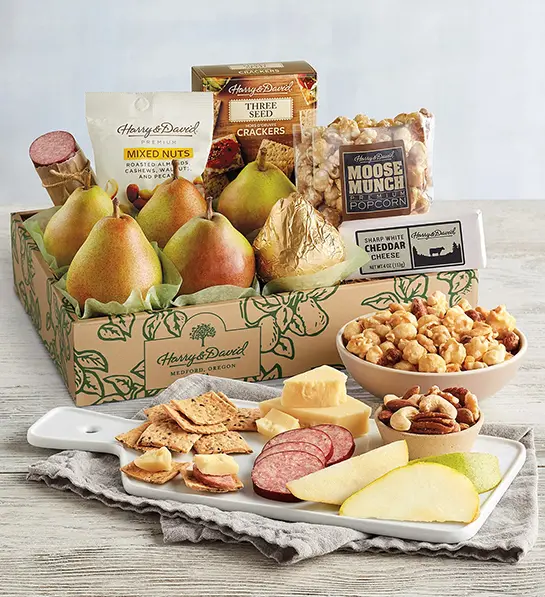 Mother-in-law gifts with a box of pears, Moose Munch, cheese, meat, and other snacks.