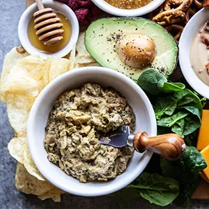 Spinach dip on a snack board.